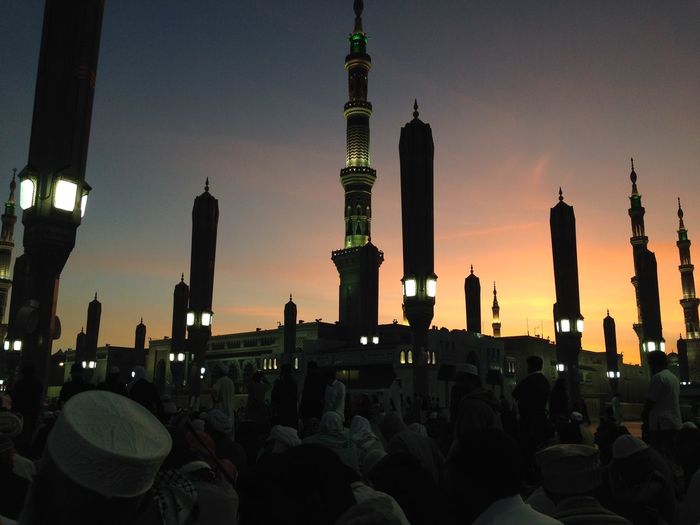 People in front of mosque during sunset