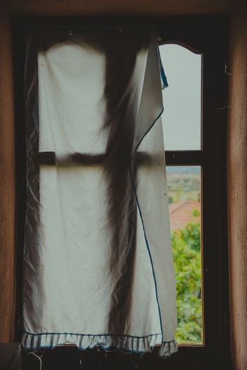 Clothes hanging on window at home