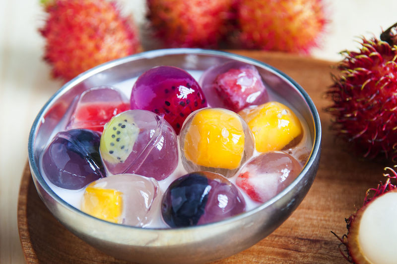 Close-up of fruit jelly and rambutans on table