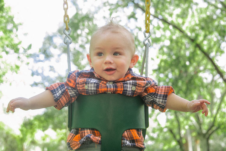 Baby boy enjoying on swing