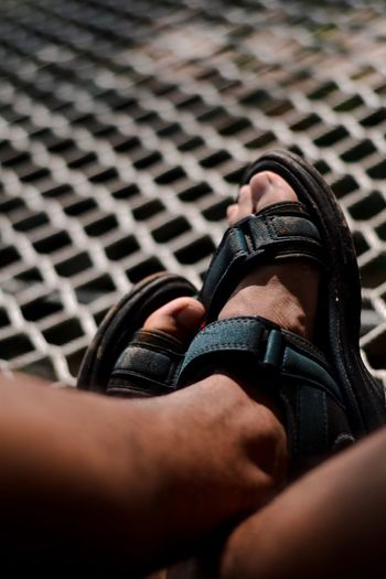 Low section of man wearing sandals