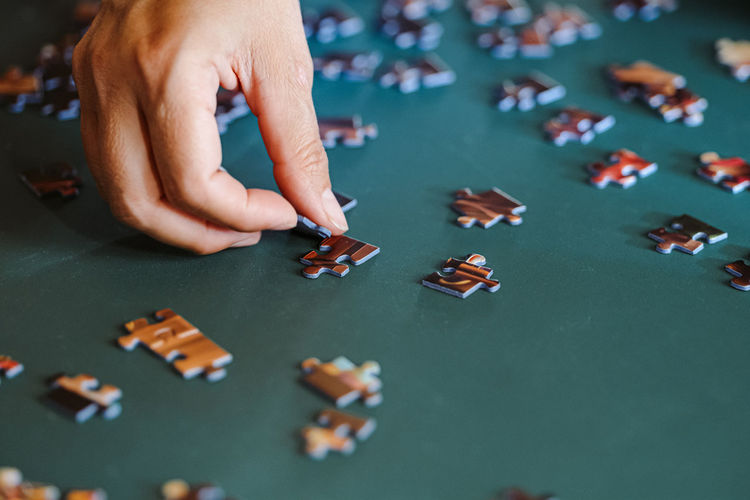 High angle view of woman playing with puzzle