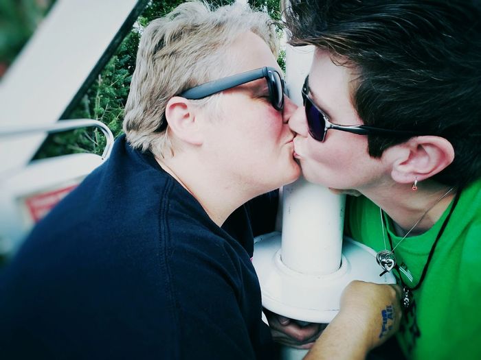 Lesbian couple kissing on ferris wheel