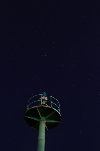 Low angle view of tower against sky at night