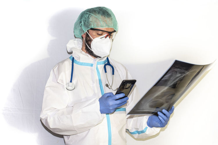 Doctor with protective suit for covid19 with laboratory equipment. white background.