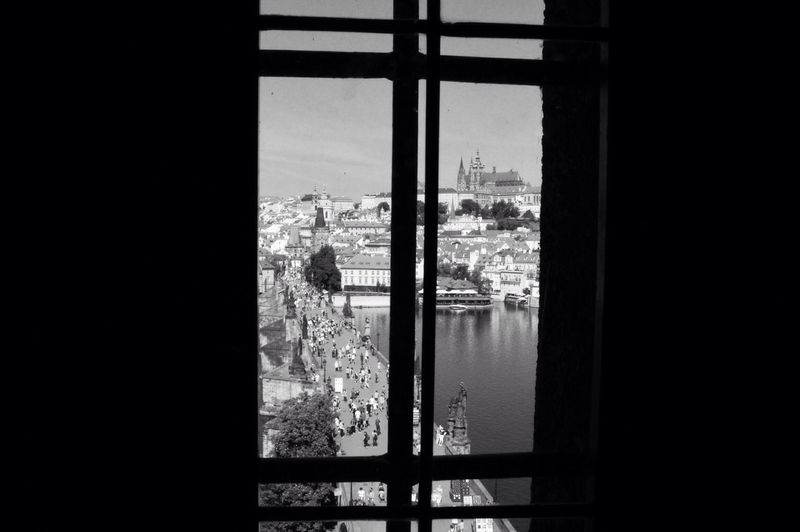 Close-up of cityscape against sky seen through window