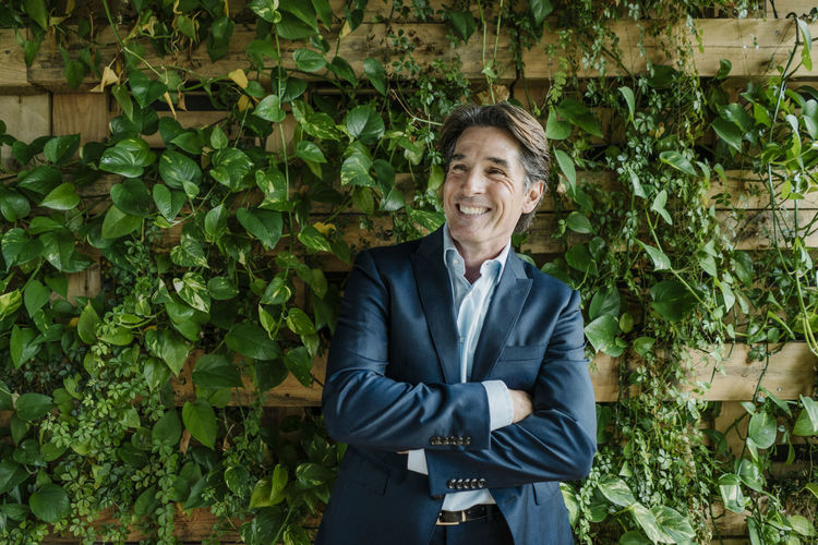 Smiling businessman in green office