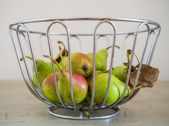 Close-up of apples in container on table