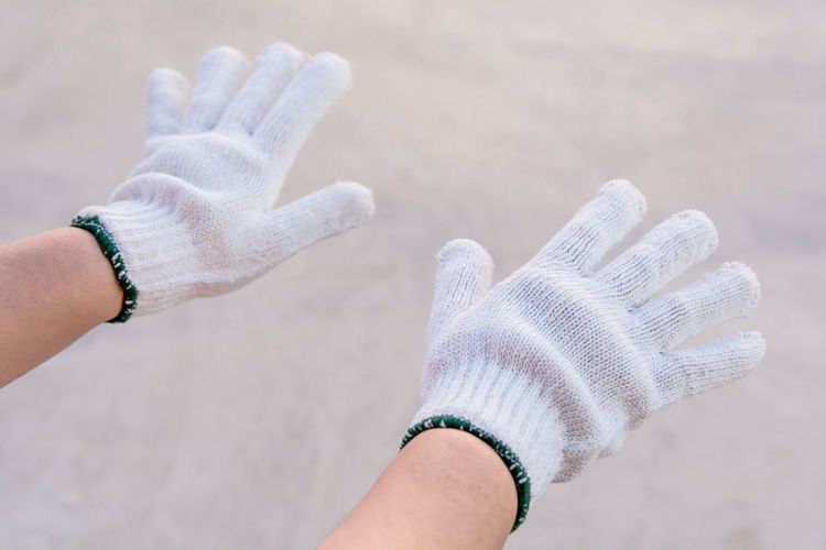 Cropped hands of person wearing gloves