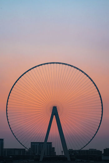 Silhouette ferris wheel against sky at sunset