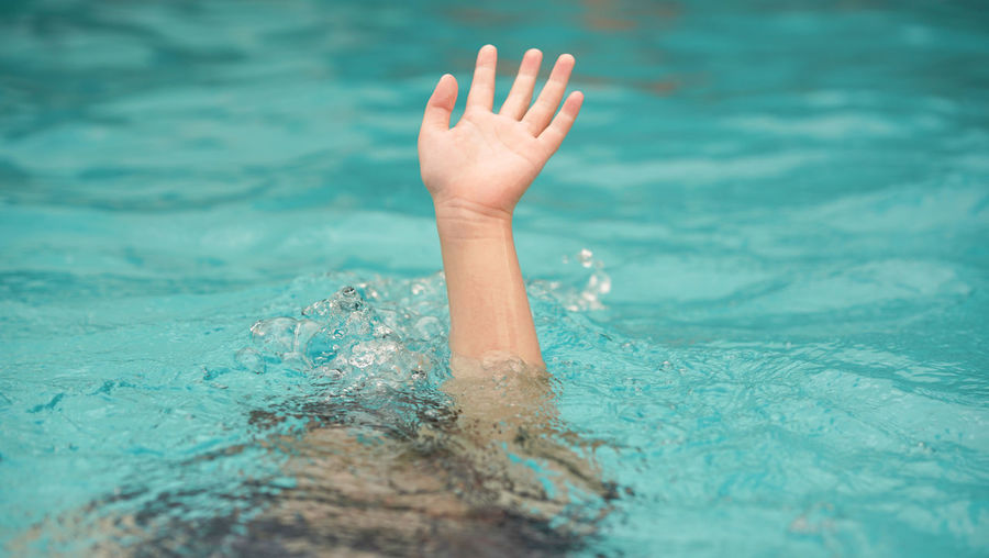 Cropped image of woman swimming in pool