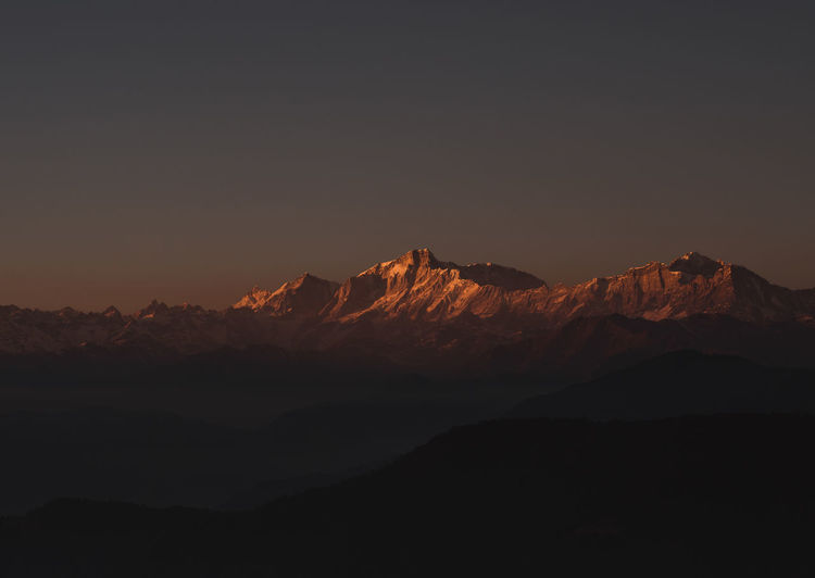 Sun setting over mount kedarnath in uttarakhand, india