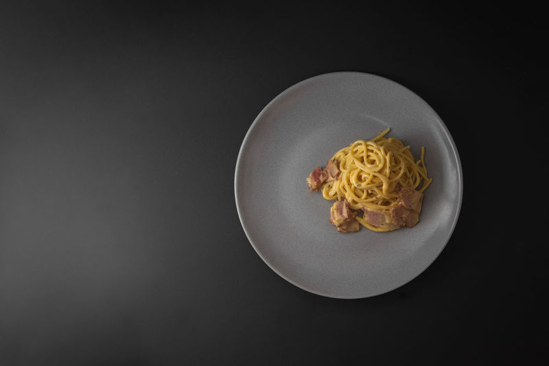 Directly above shot of food on table against black background