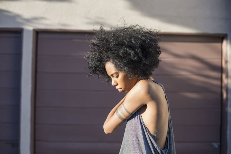 Profile of a young woman standing outside