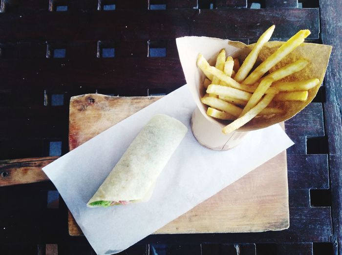 High angle view of wrap on table with fries