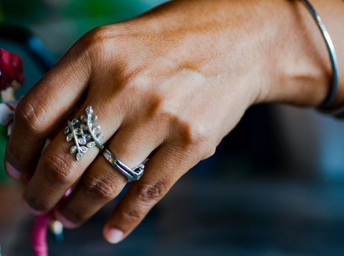 Cropped hands wearing ring