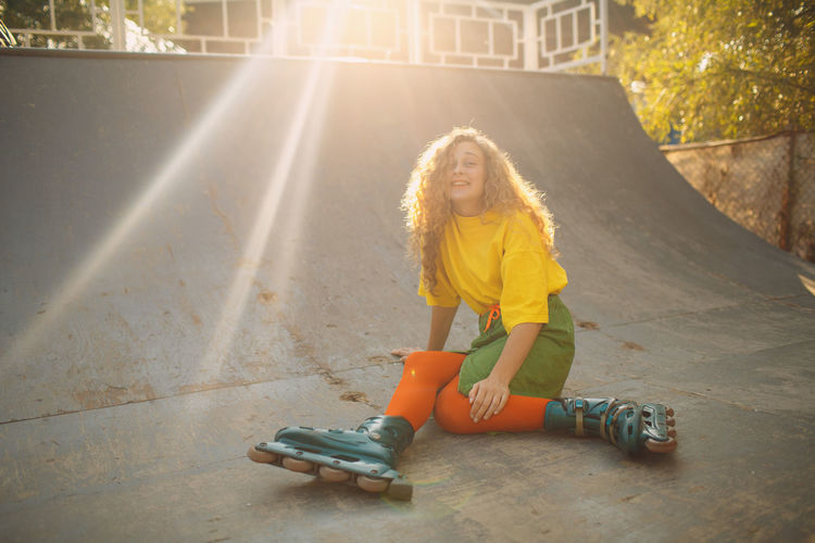 Portrait of smiling woman skating on ramp