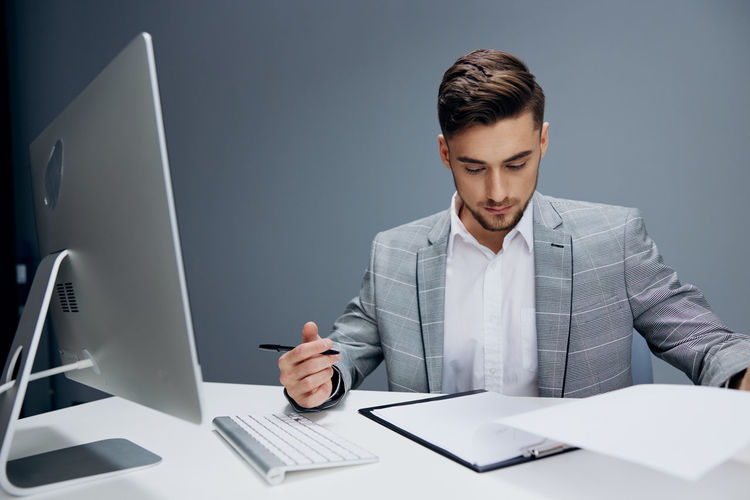 Businessman using laptop while sitting on table