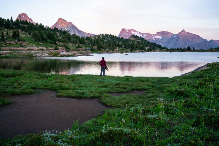 Photographer watches sunset at edge of limestone lake