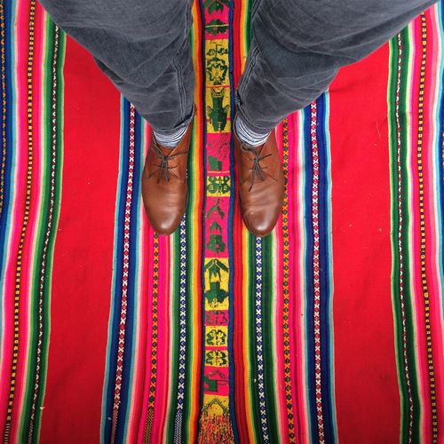 Low section of person standing on carpet