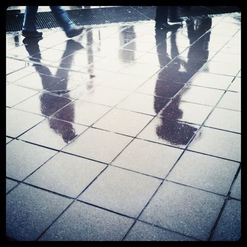 Shadow of people on tiled floor