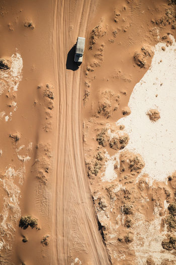 High angle view of van on dirt trail at desert