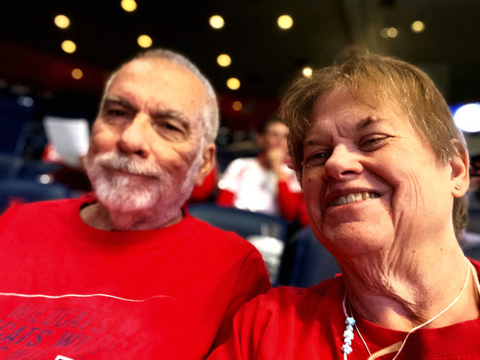 Close-up portrait of senior couple smiling while sitting on seats