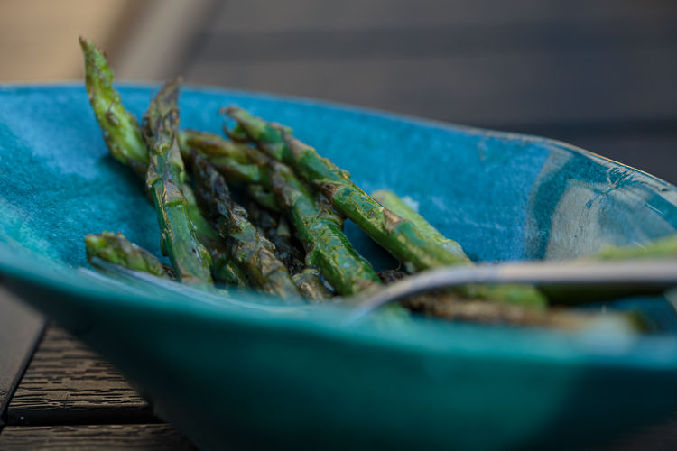 Close up of asparagus in a turquoise bowl