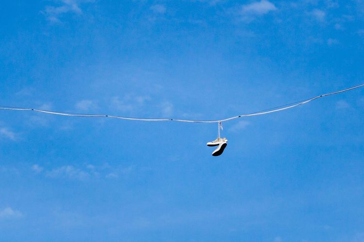 Shoes on a wire - blue sky