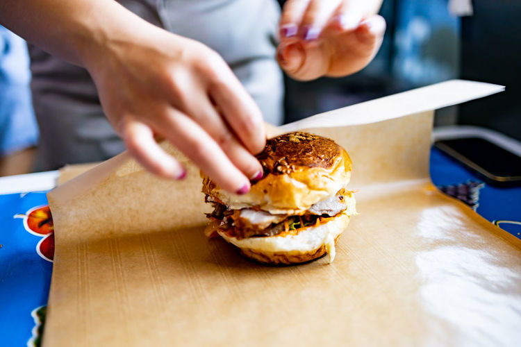 Cropped hand of person preparing food