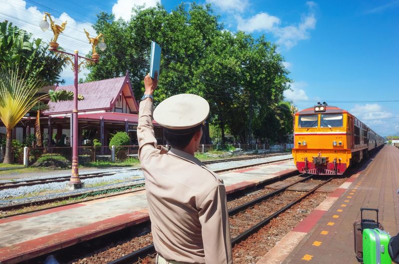 Train on railroad track in city against sky