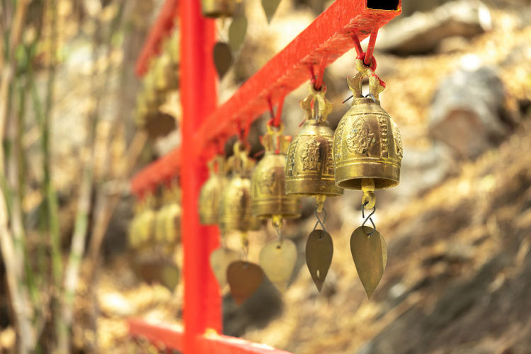 Close-up of bell hanging on land