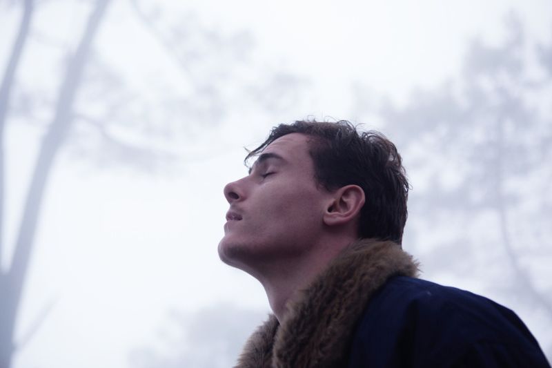 Low angle view of man against trees