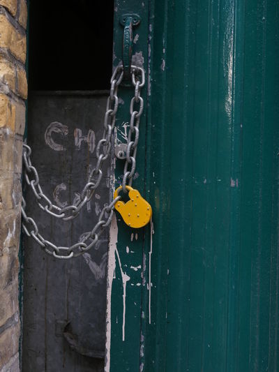 Close-up of padlocks on metal door
