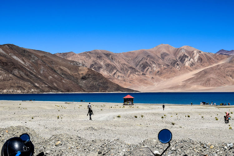 Scenic view of pangon tso lake against clear blue sky