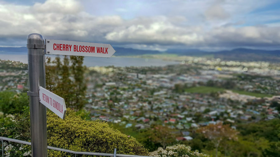 Information sign on landscape against sky