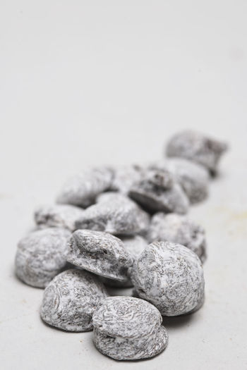 Close-up of stones on table against white background