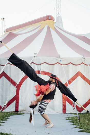 Circus acrobats practicing dance outside circus tent
