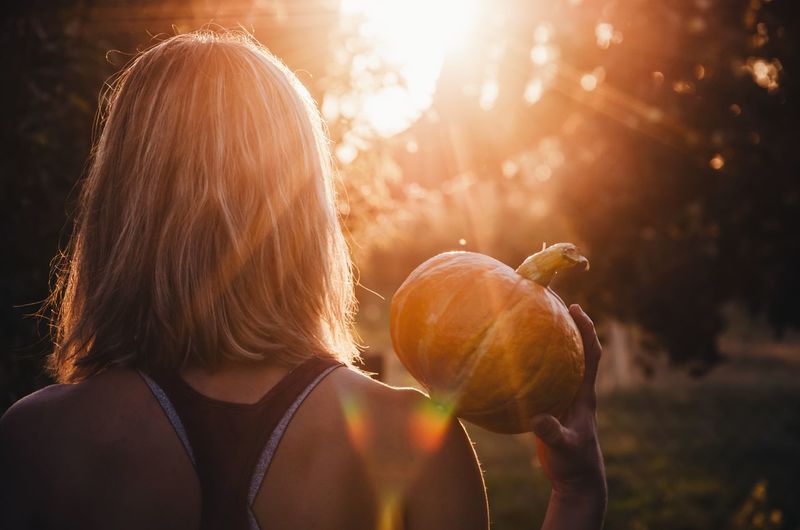 Portrait of woman holding pumpkin