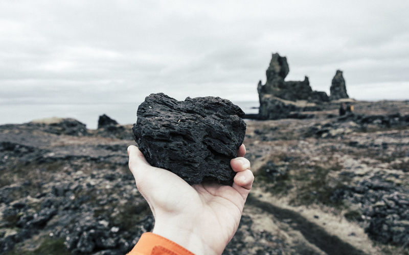 Silhouette of person standing on rock formation