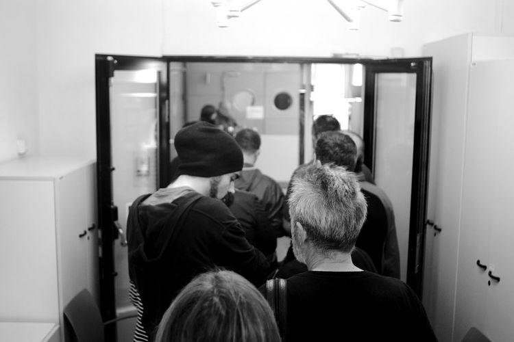 Rear view of people sitting in room