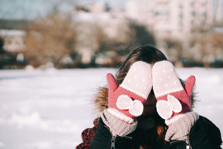 Close-up of woman with umbrella during winter