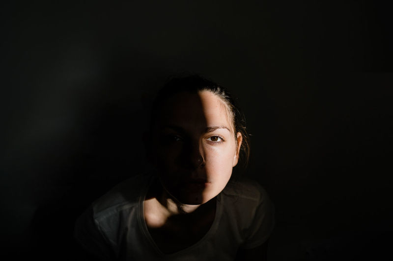 Portrait of young woman in darkroom