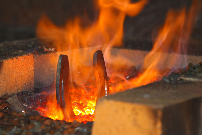 Close-up of horseshoe burning in furnace