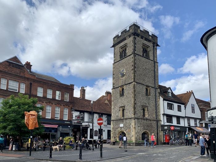 Street view of st albans medieval town, hertfordshire, england, uk. market place, clock tower