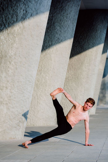 Low section of man skateboarding on wall