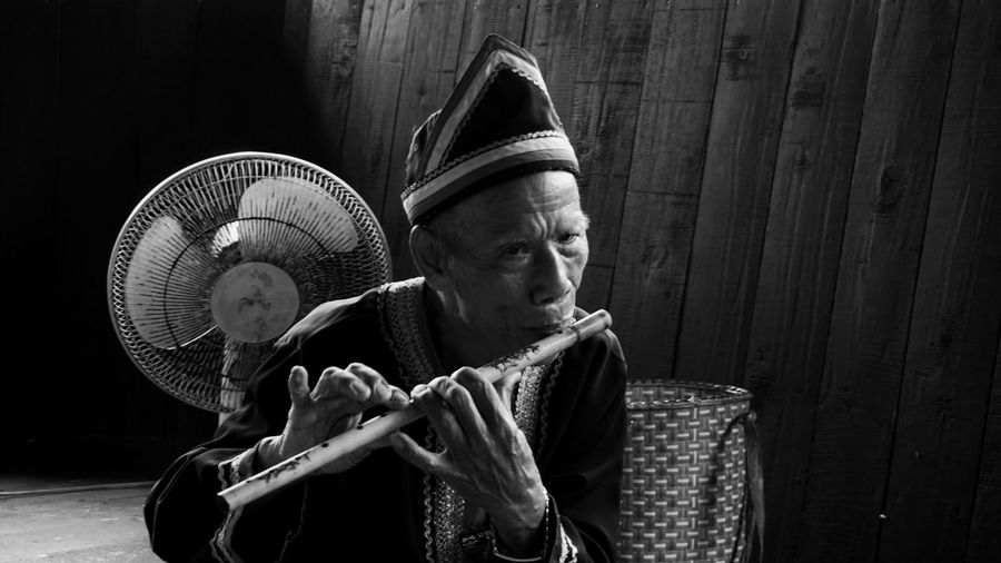 Portrait of man playing flute 