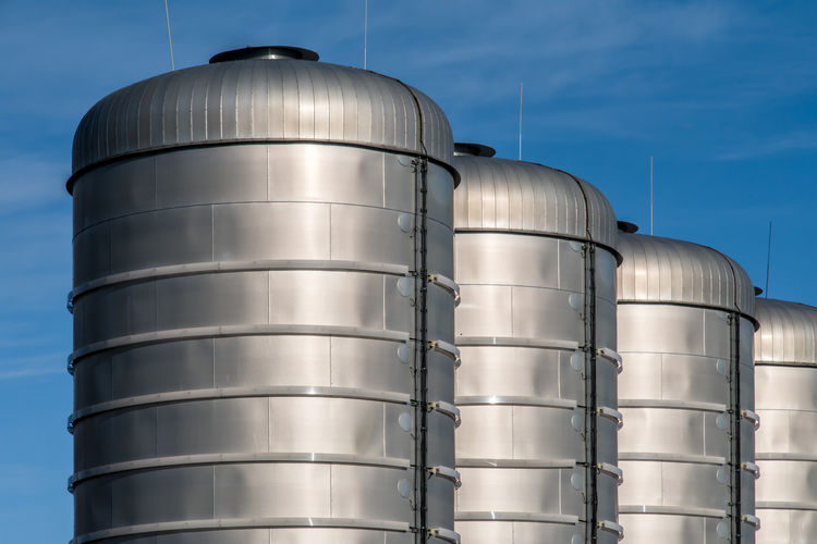 Large metallic containers in factory outdoors