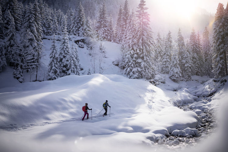 Couple ski touring together during winter