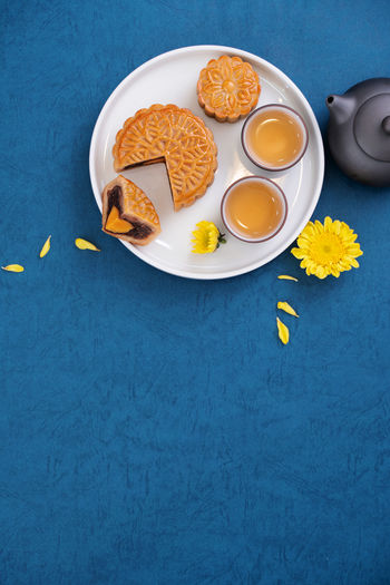 Minimal simplicity layout moon cakes on blue background for mid-autumn festival, creative food .